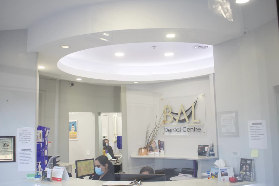 Bal Dental Centre reception with CDCP and insurance information in Scarborough